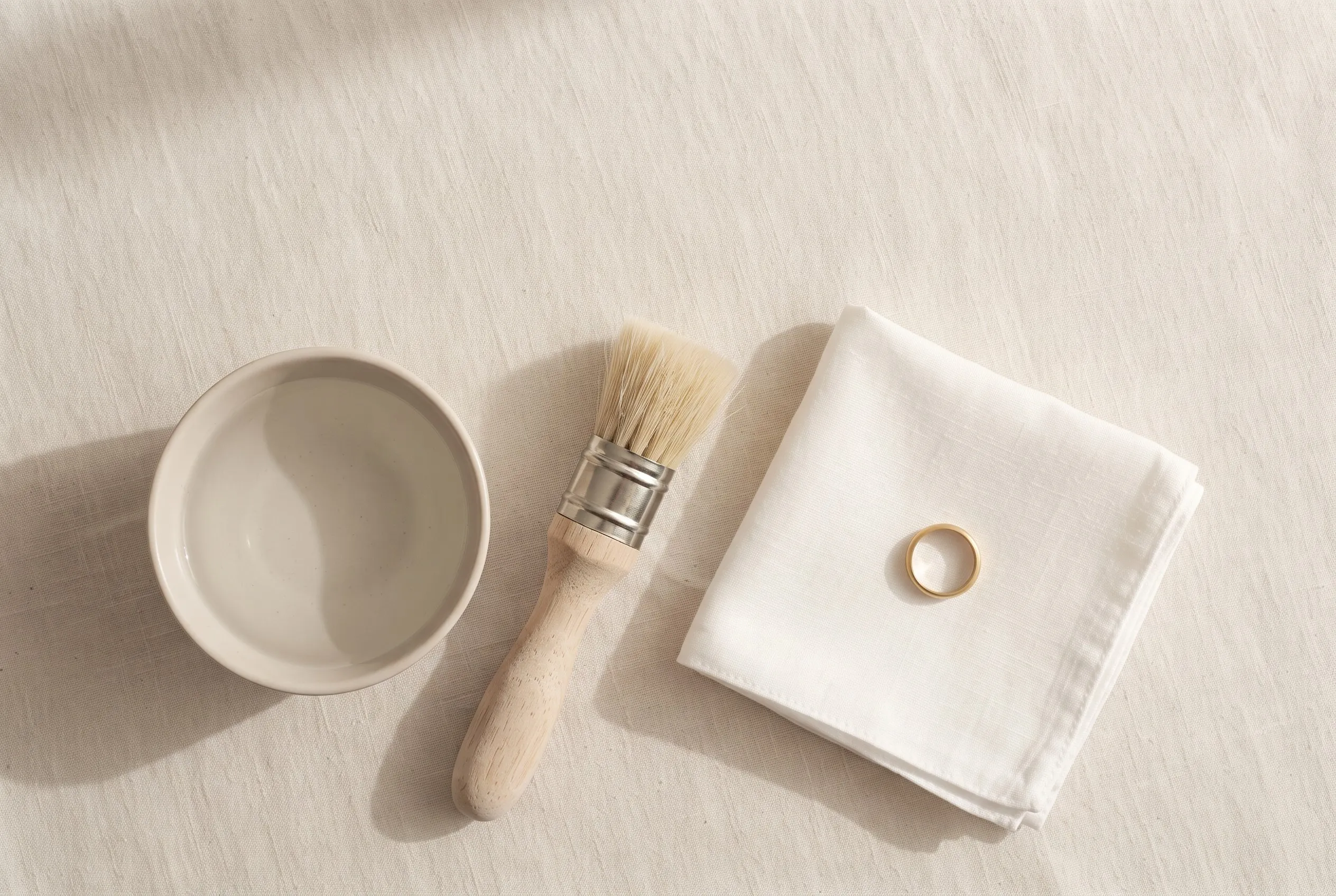 Warm water, mild soap and a soft brush laid out for cleaning a piece.